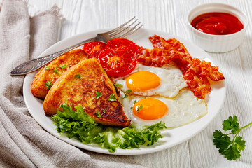 irish breakfast of fried eggs, bacon, potato farls