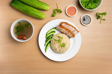 Roast Pork Rice with raw cucumber, Coriander, salad, sauce and soup served in a dish isolated on wooden background top view