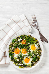 green shakshuka on white plate, top view