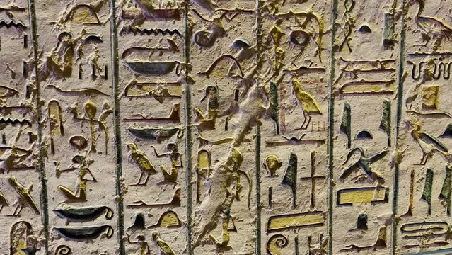 A small stone with hand carved Ancient Egyptian hieroglyphics. This stone is part of a Museum collection of Ancient Egyptian antiquities.