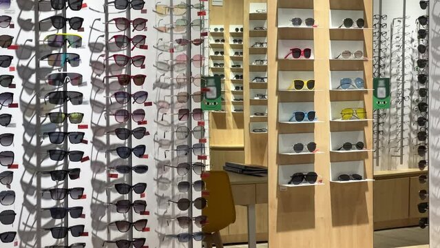 Sunglasses in assortment on the shelves of an optics store