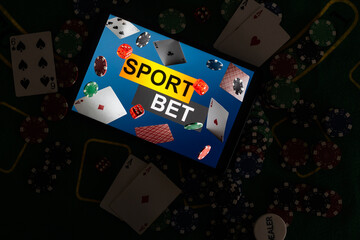 Smartphone with poket table on screen, playing cards and chip cards on poker table. Online casino.