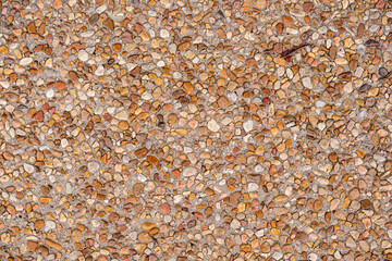 Pebble inlaid concrete sidewalk background texture