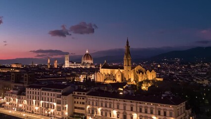Establishing aerial view of Florence Cathedral, Firenze Cattedrale di Santa Maria del Fiore, Ponte Vecchio and Arno River on a beautiful colourful dusk sky, Tuscany region of Italy Florence