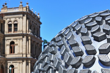 Sphere-shaped aluminium form made with vegetable steamers-Treasury Building background. Brisbane-Australia-010 - obrazy, fototapety, plakaty