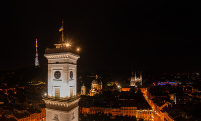 Fototapeta premium view on Lviv city hall at night from drone