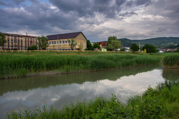 Fototapeta premium Romania, Bistrita, School near the Bistrita River in June 2022