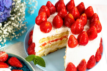 selective focus. festive berry cake. homemade strawberry cake cut. Strawberry pie decorated with fresh strawberries stands on a plate. Ice cream and strawberry cream. Cut off a piece. 