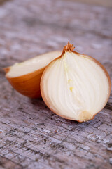 A halved onion on a wooden surface background.