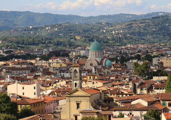 Fototapeta na wymiar Domes of the synagogue of the city of Florence in the region of Tuscany and also the bell tower of a catholic church