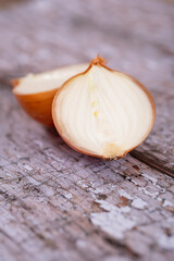 A halved onion on a wooden surface background.