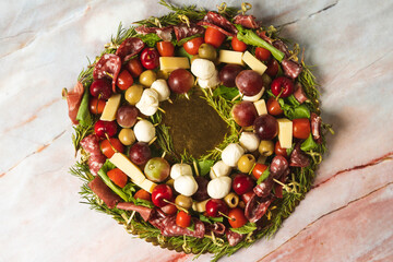 charcuterie board ring with cheeses, crackers, strawberries, olives, grapes, pastrami, salami,...