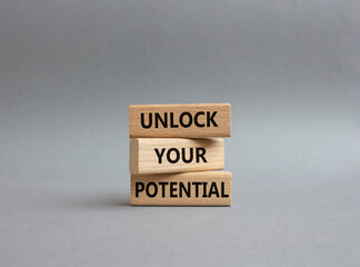 Unlock your Potential symbol. Wooden blocks with words Unlock your Potential. Beautiful grey background. Business and Unlock your Potential concept. Copy space.