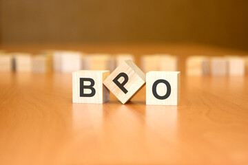 BPO text on wooden blocks, financial business concept, blue background. BPO - short for Business...