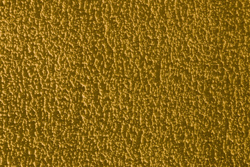 The surface is made of rough old plaster on the wall.