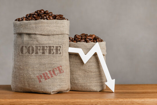 Lower prices for black coffee beans. Poor harvest of coffee beans, world food crisis. Decline in the cost of coffee futures and derivatives.Decrease graph, arrow pointing down