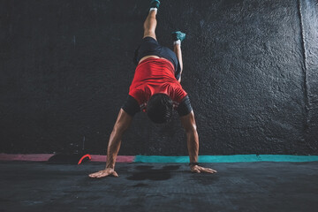 Latin young man in his crossfit exercise routine. rising with hands