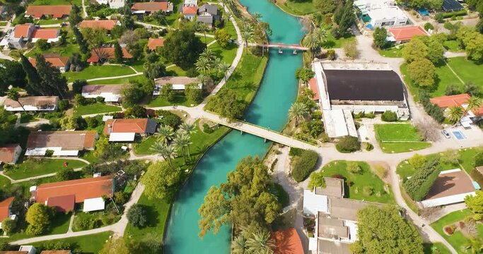 Aerial view of the town with hills in the background and Kibbutzim Stream, Nir David, Northern District, Israel.
