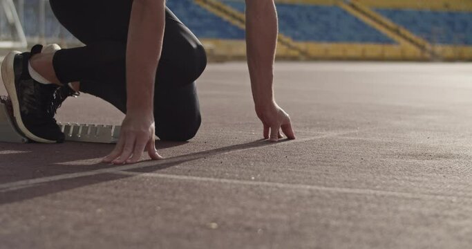 Cropped runner preparing for race