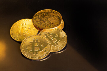 Bitcoin, bitcoin coins placed on a dark reflective background, selective focus.