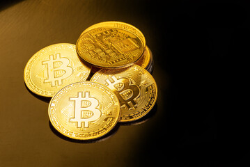 Bitcoin, bitcoin coins placed on a dark reflective background, selective focus.