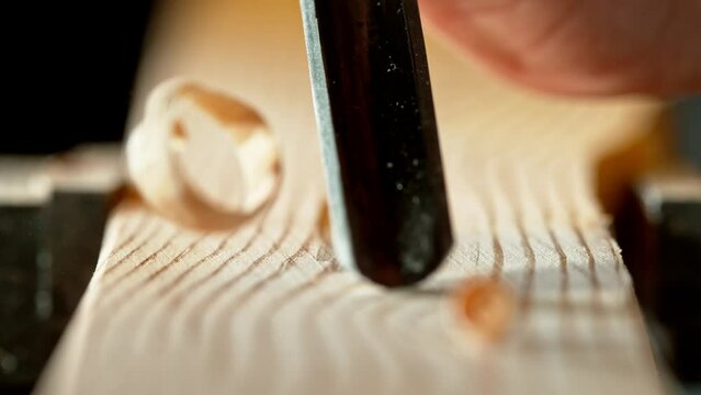 Super slow motion of detail of carving wood with a chisel. Low depth of focus, super macro shot. Filmed on high speed cinema camera, 1000 fps.