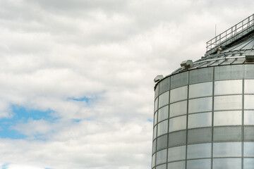 A large modern plant for the storage and processing of grain crops. view of the granary on a sunny day against the blue sky. End of harvest season.