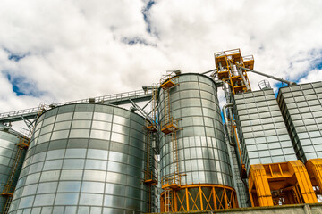 A large modern plant for the storage and processing of grain crops. view of the granary on a sunny day against the blue sky. End of harvest season.
