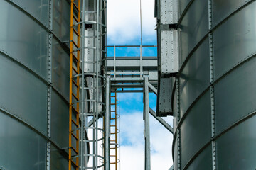A large modern plant for the storage and processing of grain crops. view of the granary on a sunny day against the blue sky. End of harvest season.