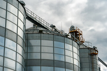 A large modern plant for the storage and processing of grain crops. view of the granary on a sunny day against the blue sky. End of harvest season.