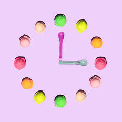 Colorful ice cream balls and spoons on light pastel purple background. Creative tasty food concept....