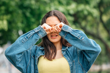 outdoor girl rubbing her eyes