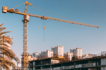 Construction Crane Is Involved In Development Of A New Multi-storey Residential Building.