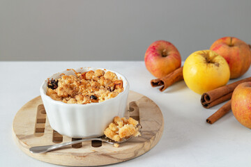 Apples baked under crumble. Apples and cinnamon sticks in the background. Autumn background....