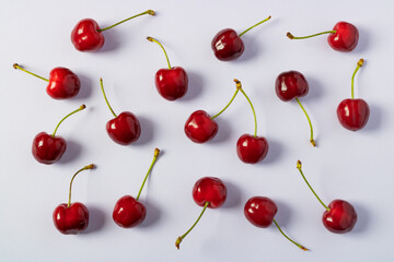 Cherry background, texture, pattern. Cherry pattern. Flat lay cherry on a pink background.Top view