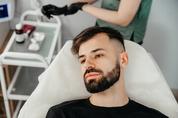 Obraz premium Mesotherapy. Injections with vitamins for hair growth on bald parts of the head in a young man