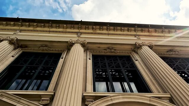 Time Lapse views looking up at the ornate details of the Illinois Supreme Court in Springfield, IL, USA. Tall columns reach to the cloudy blue sky. Partial view from directly below.