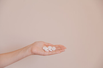 
hand holds pills, on a light background. Medicine in the palm of your hand. Health is in your hands