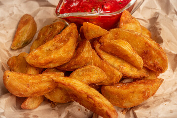 Crispy fried potato wedges with tomato sauce.
Fish and chips.