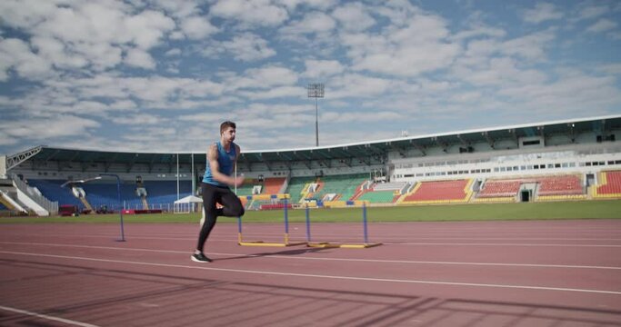 Sportsman practicing long jump on arena.Slow Motion