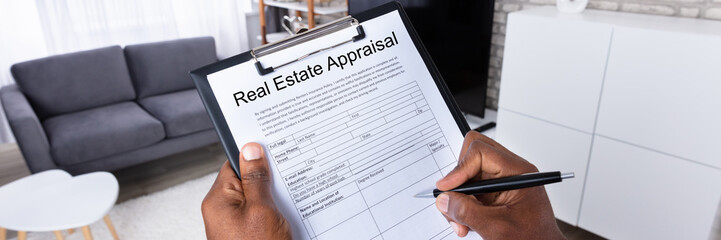 Man Filling Real Estate Appraisal Form