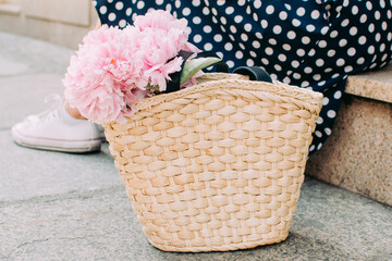 Girl holding flowers legs close up