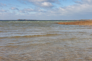 Lake in windy and cloudy weather. Autumn