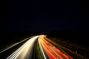 Fototapeta na wymiar Langzeitbelichtung - Autobahn - Strasse - Traffic - Travel - Background - Line - Ecology - Highway - Night Traffic - Light Trails - High quality photo