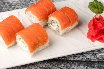 Rolls, sushi, sushi with fish on a wooden white background