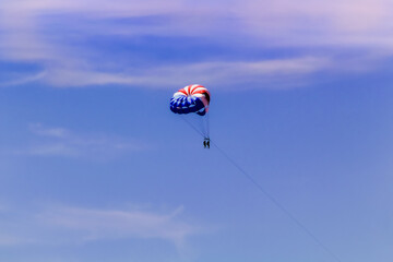 Floating on a parachute in the sea
