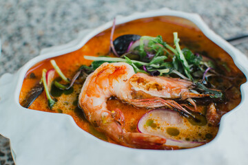 Soup with shrimp and seafood close-up