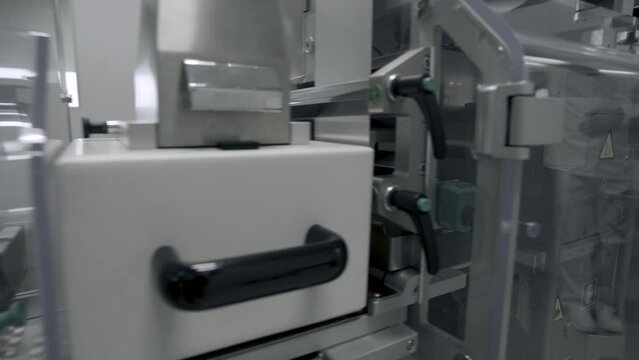 Photo sensor detect medicine bottles on line conveyor in pharmaceutical industry. Industrial Machine for quality of medical product in line conveyor processing. Industrial and technology concept.