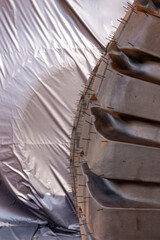 Huge rear wheels of dump truck at unusual angle closeup.