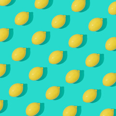 Creative summer pattern made of lemons on bright blue background. Summer art. Minimal citrus fruits aesthetic. Flat lay, top view.